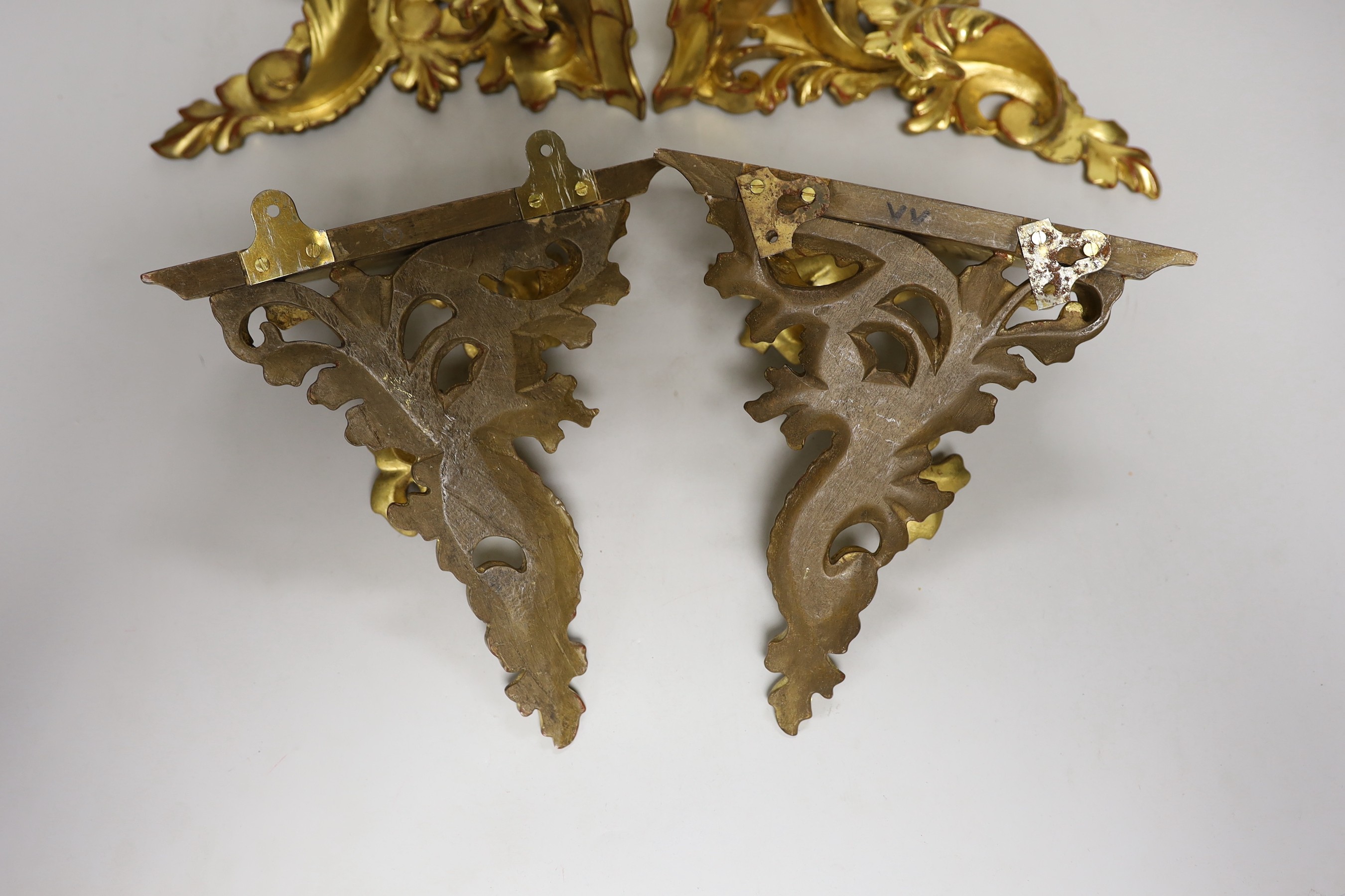 A set of four gilt wood wall brackets 22.5cm tall x 20.5cm wide